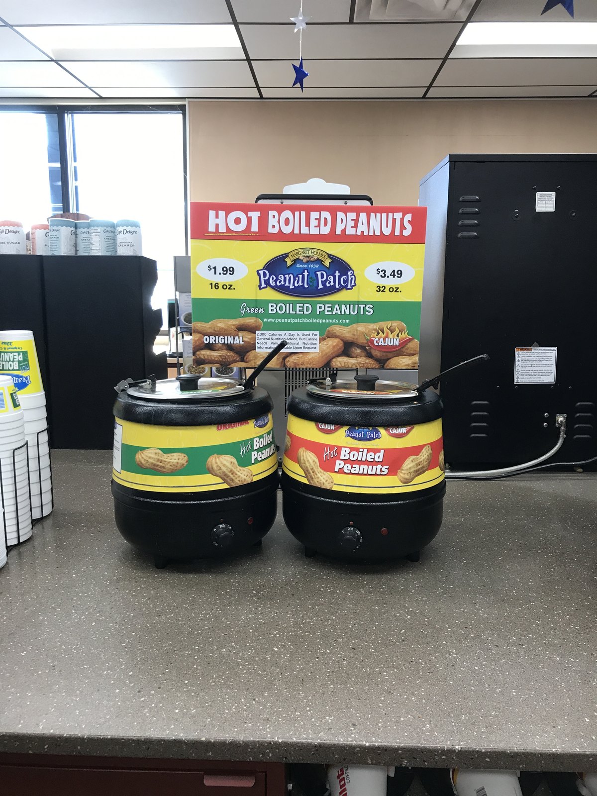 Hot boiled peanuts for sale beside the canned ones — the shelf-stable version of the same food