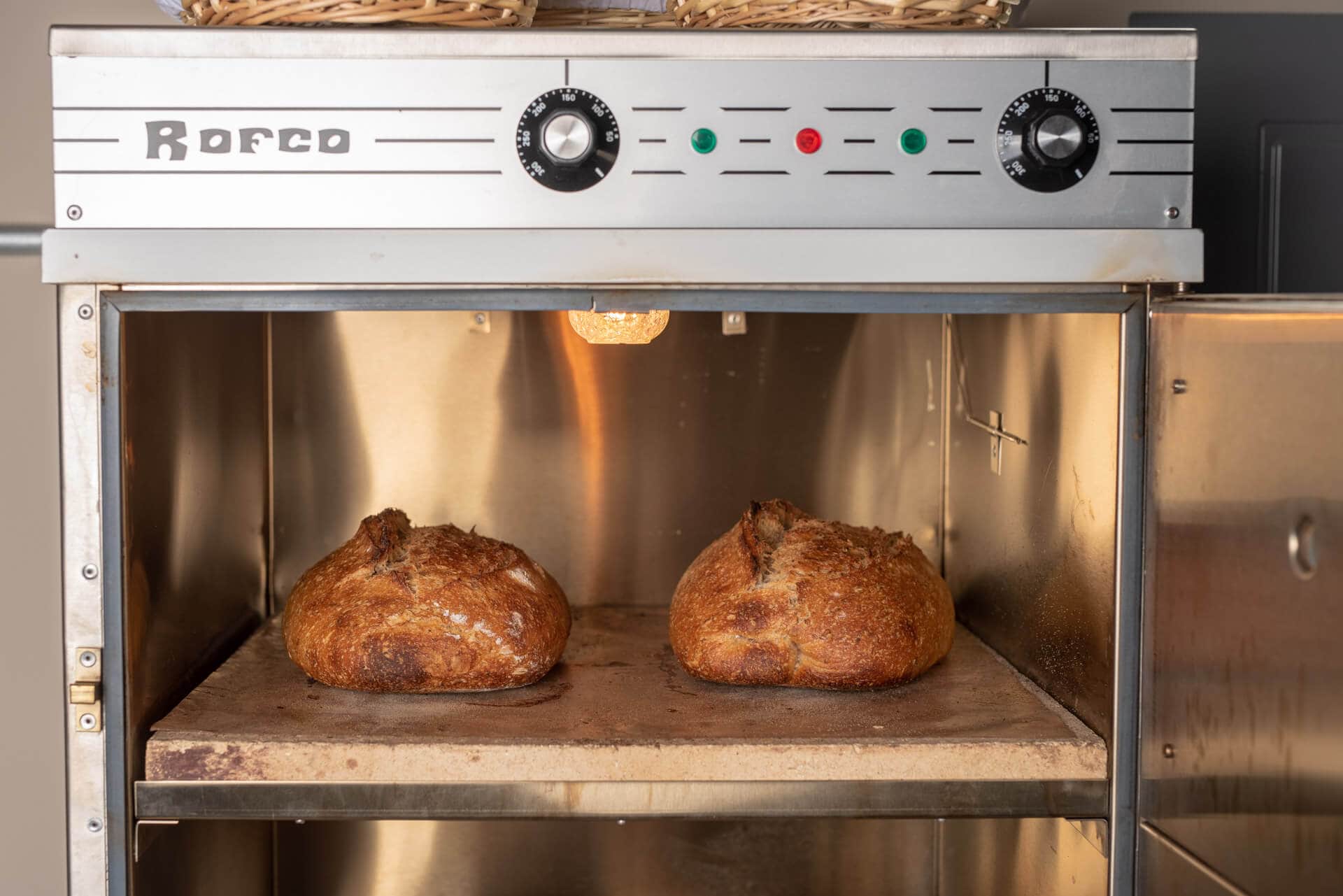 Loading scored loaves onto the hot stone decks