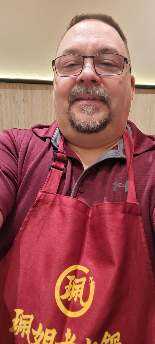 Me, in the restaurant's own apron. They hand them out because the oil spits