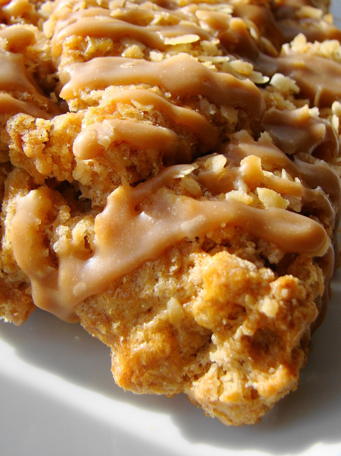 Scones drizzled with a maple glaze, in close-up