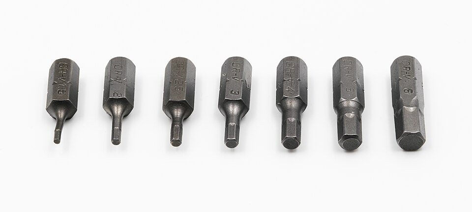 Seven dark steel hex-key bits in a row, each with a six-sided shank