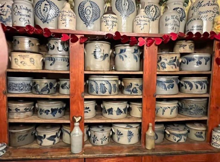 Shelves of blue-decorated salt-glazed stoneware crocks