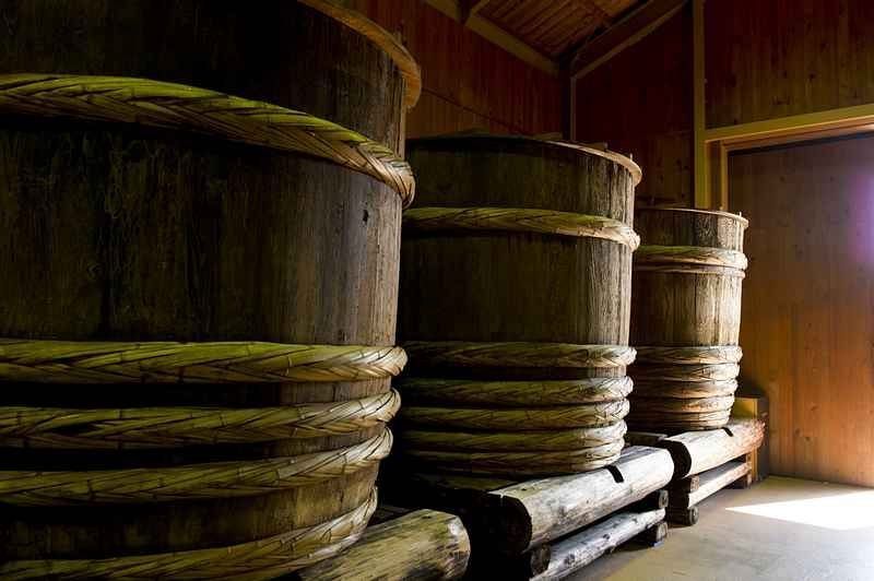 Wooden kioke barrels bound with rope, the traditional vessel for brewing soy sauce
