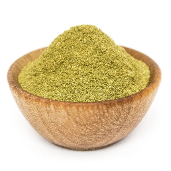 Filé powder in a wooden bowl — and note the colour, because it is the freshness test described further down this page