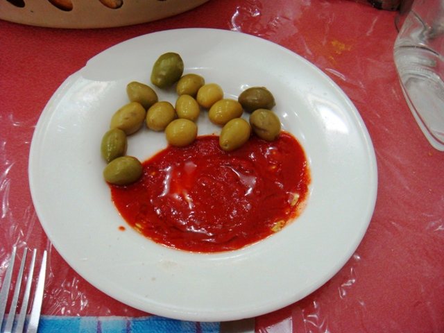 A plate of red harissa with green olives in Tunisia