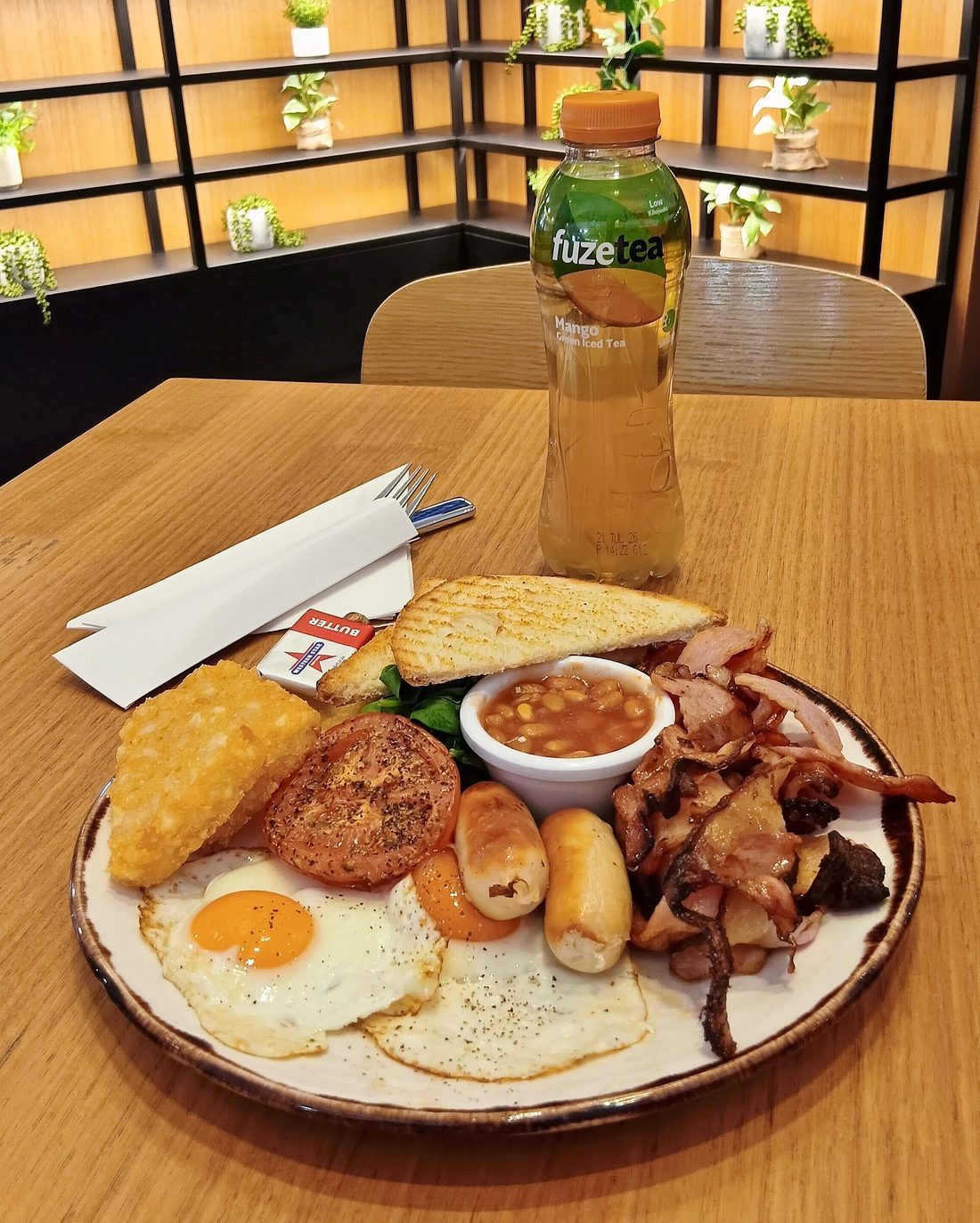 A cooked breakfast served on a tray at a cafe table