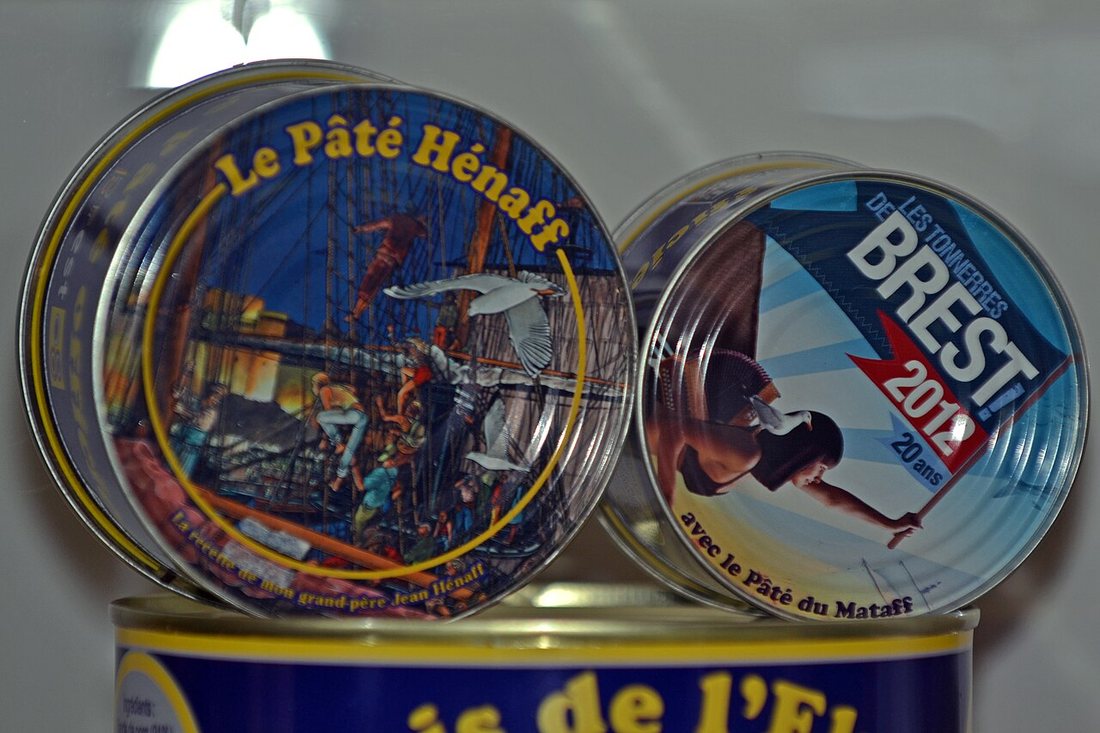 Two decorated tins of Hénaff pâté, a Breton canned pork pâté