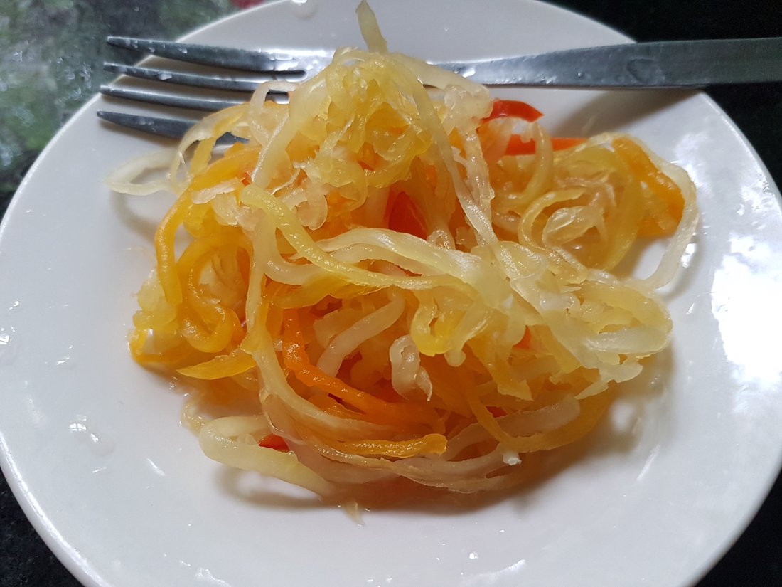 Atchara — shredded green papaya and carrot in sweet vinegar. The same word as India's achar, and a completely different method
