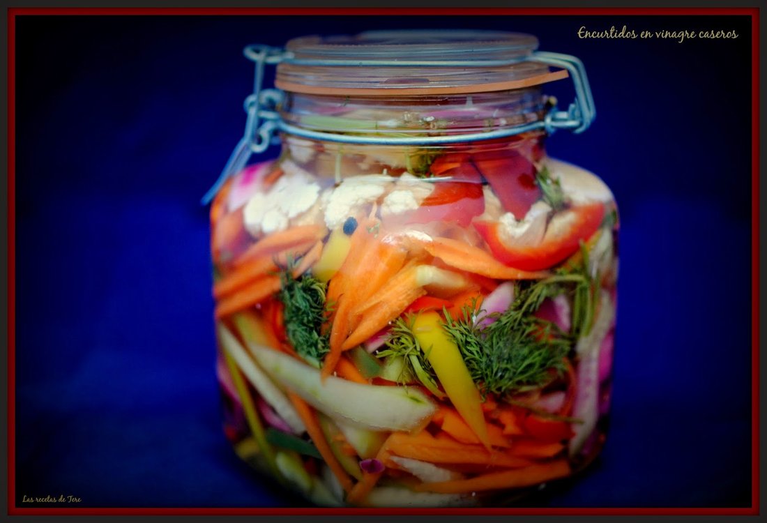 Mixed vegetables in vinegar — carrot, pepper, cauliflower. The brine is clear, which is the tell: somebody poured this acid in rather than growing it