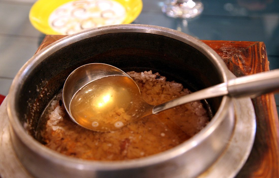 A sheet of golden Korean nurungji — the crisp scorched-rice crust lifted whole from the bottom of the pot, a product beloved enough to be sold on its own