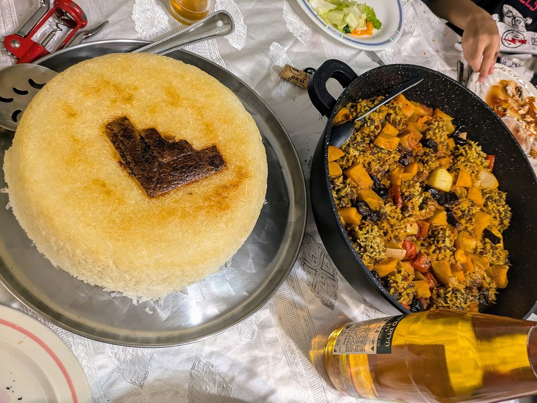 A whole disk of Persian tahdig turned out crust-side up — the shattering golden crust of rice from the bottom of the pot, unbroken and glistening