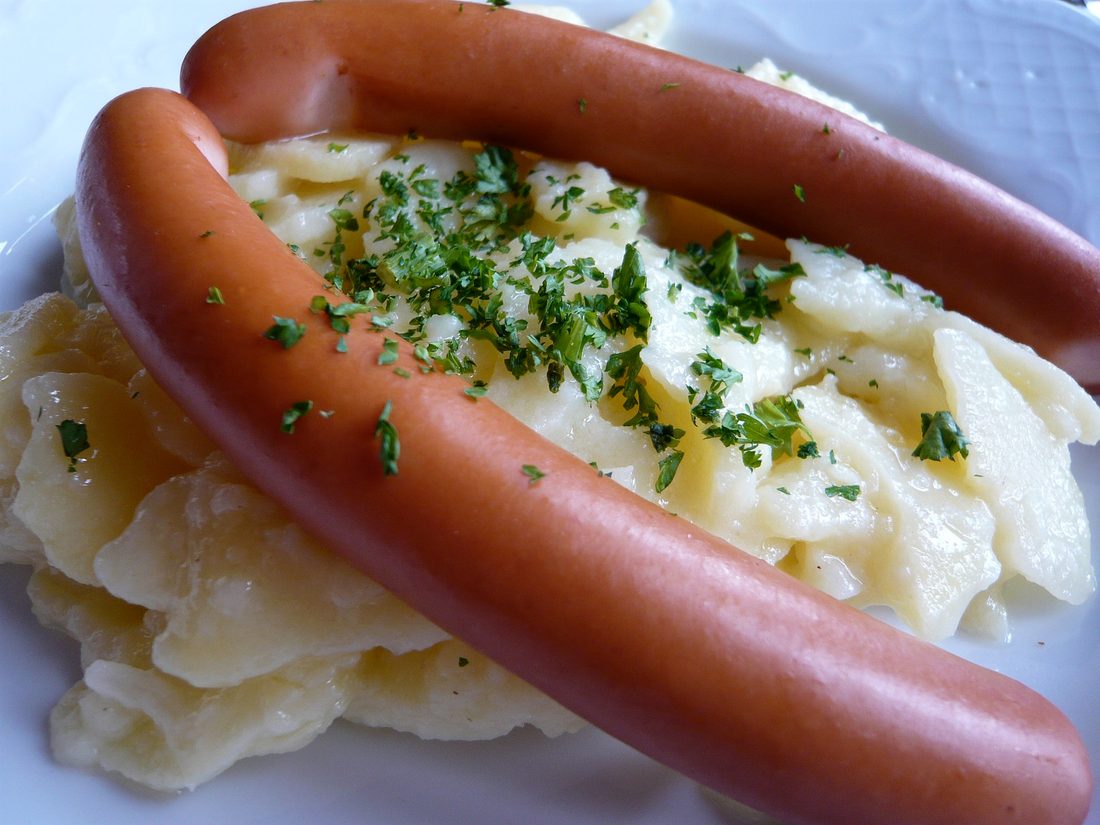 A heap of identical frankfurters — the industrial sausage: safe, cheap, and all the same.