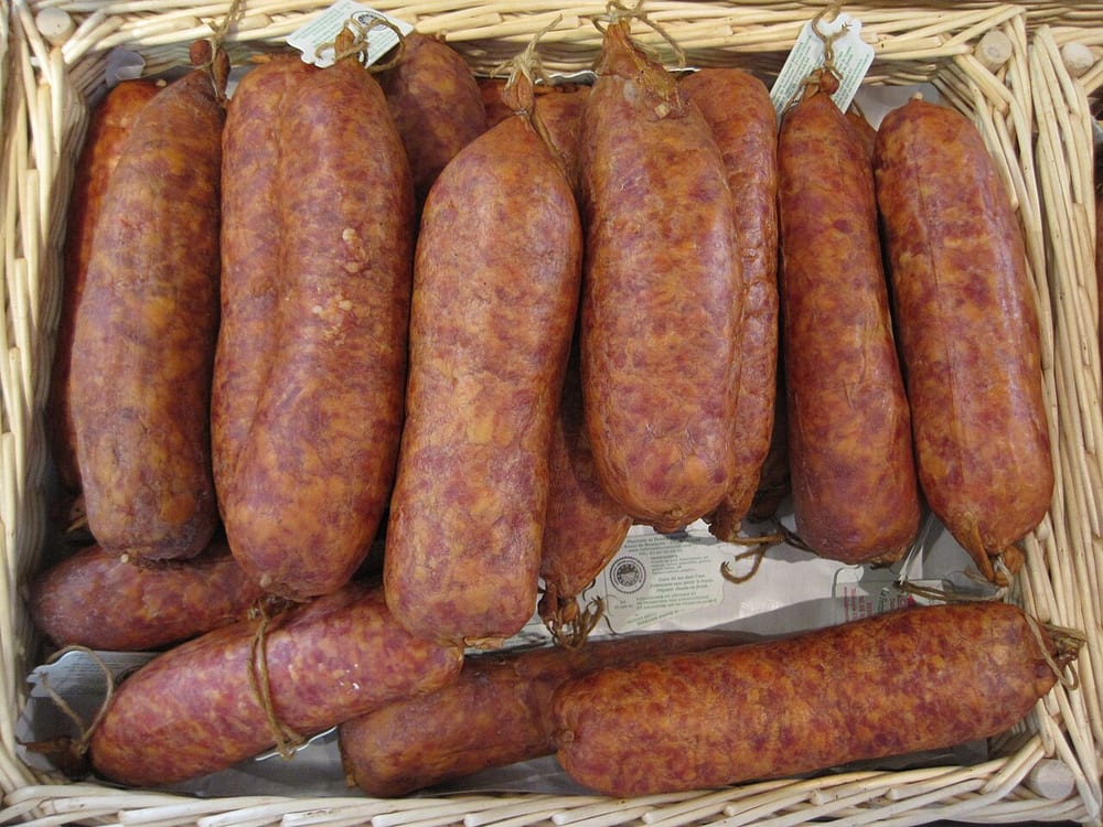 Fat Morteau sausages, the casings gone deep amber from softwood smoke