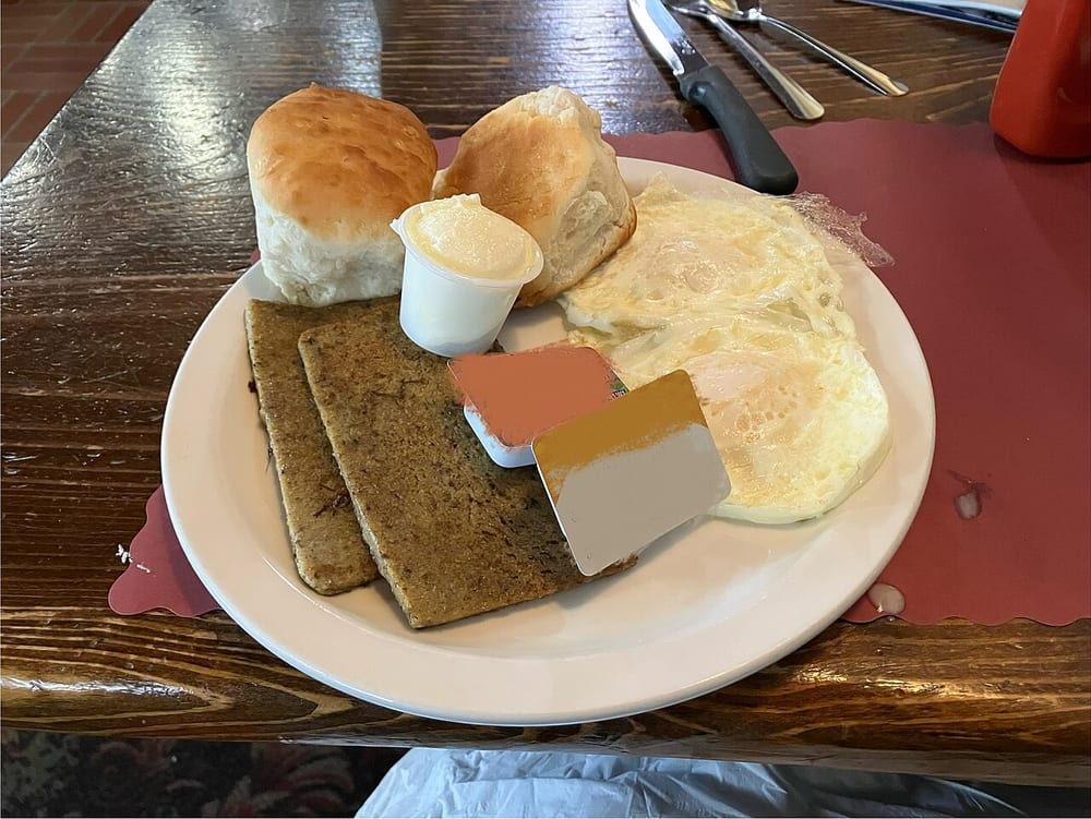 Slices of scrapple fried crisp and dark at the edges while the centers stay soft