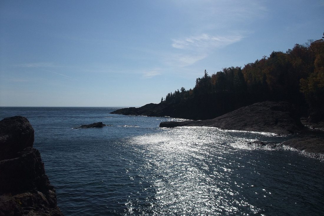 The rocky Lake Superior shoreline under a wide northern sky