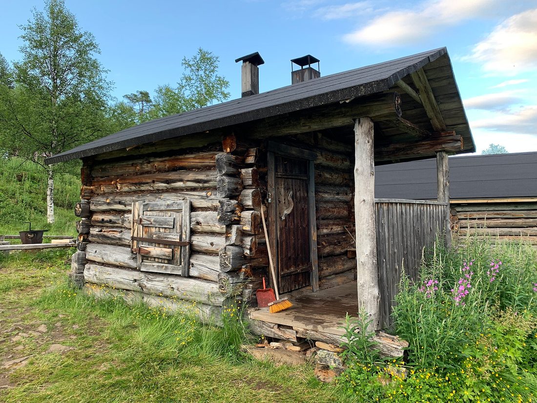 A traditional Finnish-style sauna building beside a lake in the U.P.