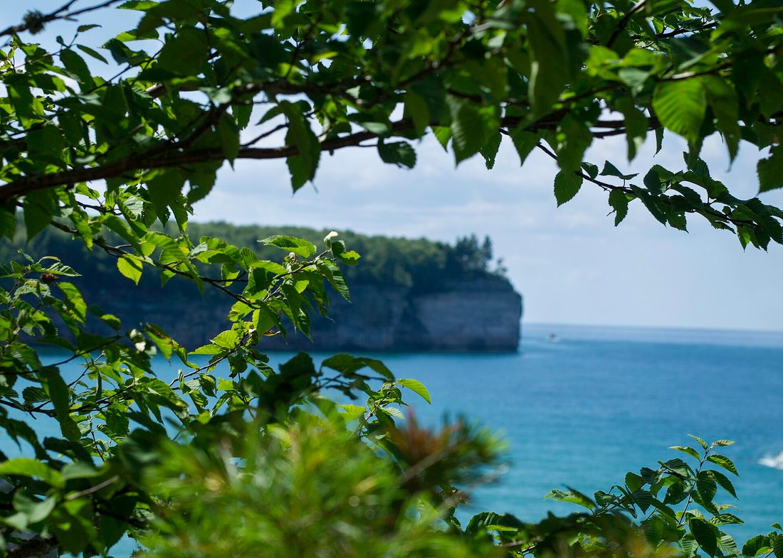 Colorful sandstone cliffs of Pictured Rocks rising above Lake Superior