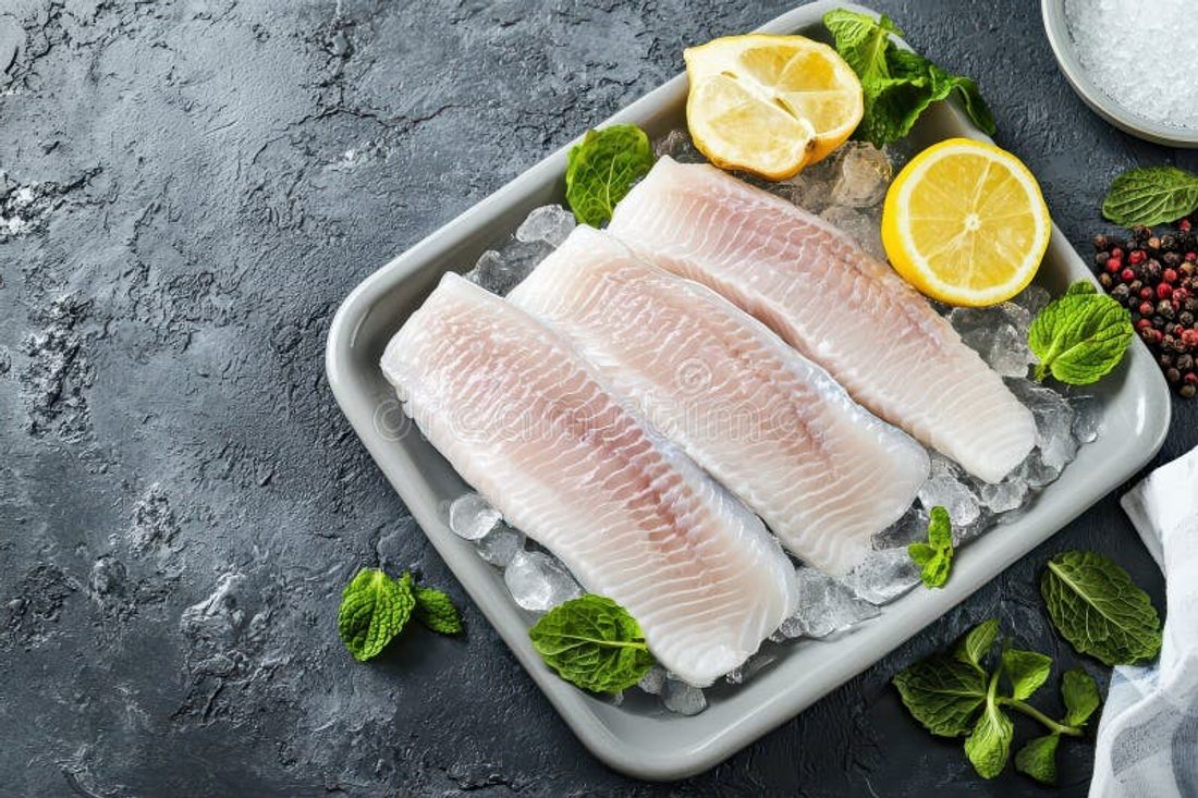 Fresh white, flaky fish fillets on ice