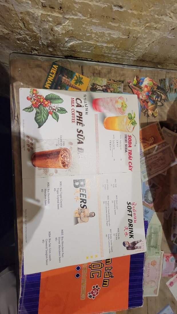 One page of the illustrated placemat menu — CÀ PHÊ SỮA ĐÁ down one side, and the plate photographs that let you order by pointing