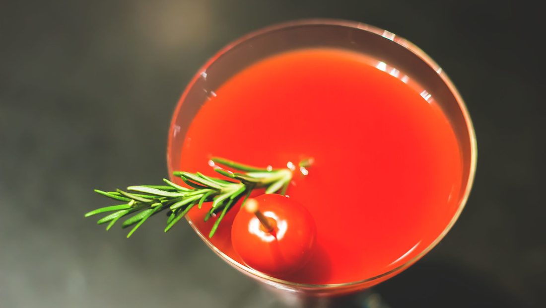 A dark splash of Worcestershire sauce being poured from the bottle into a pan of simmering gravy on the stove