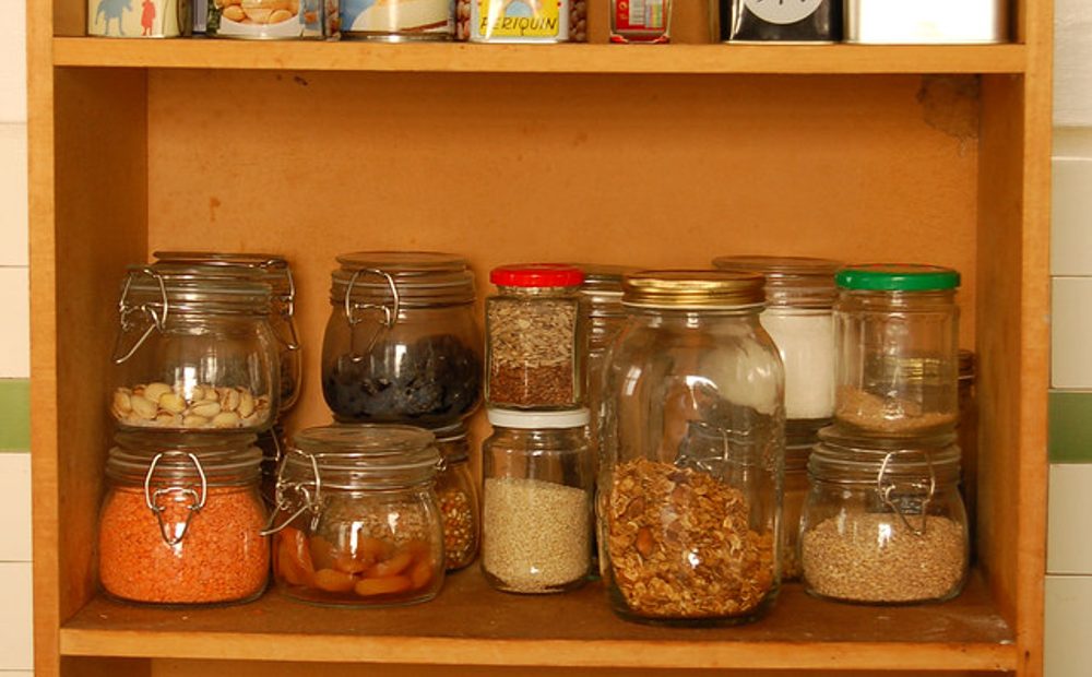 my own batch mid-aging — the jars dated on the lid, the color deepening from batch to batch on the pantry shelf (placeholder)